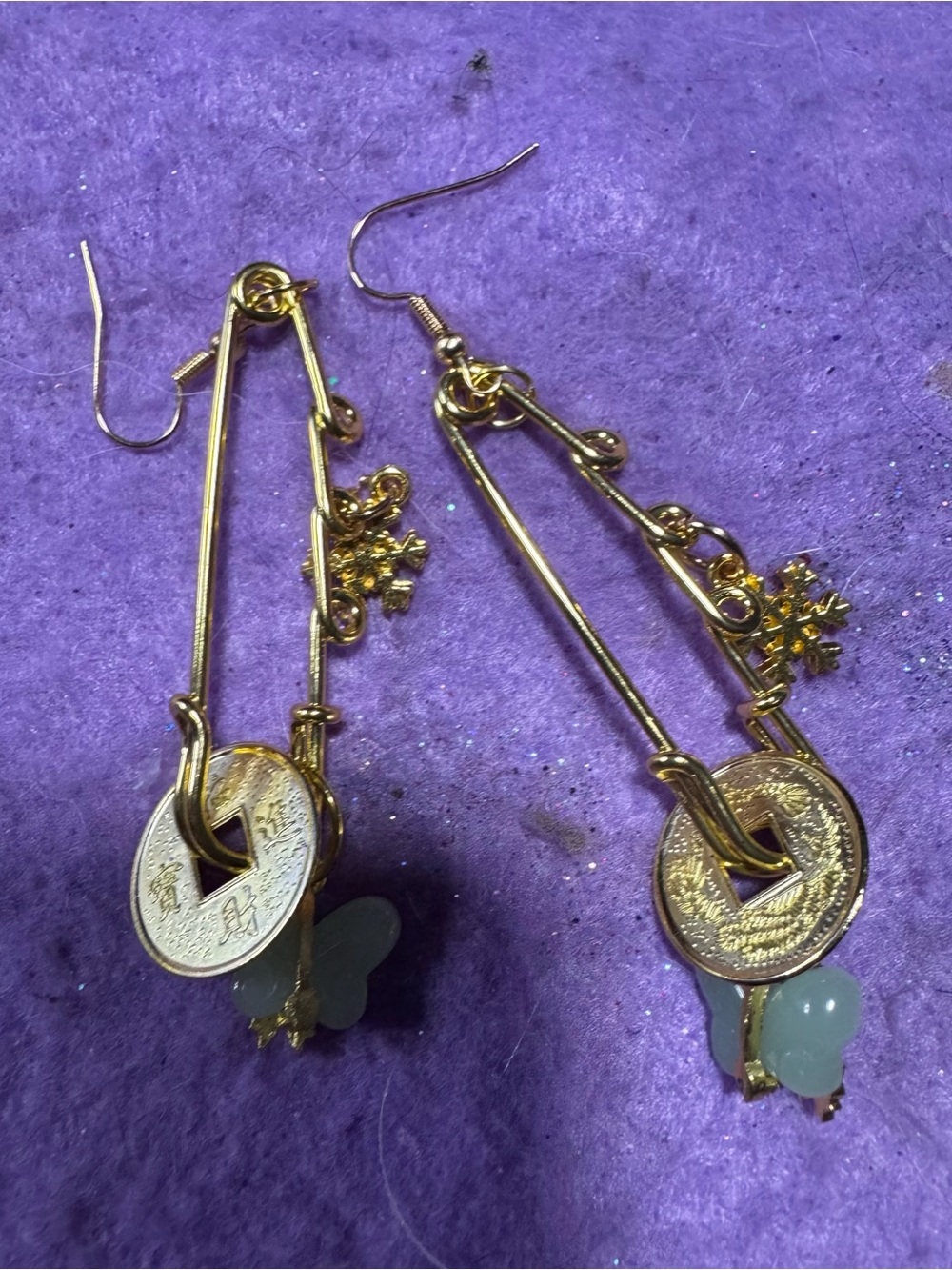 Gold-Tone safety pin earrings with Coin, butterfly Jade, & snowflake charms